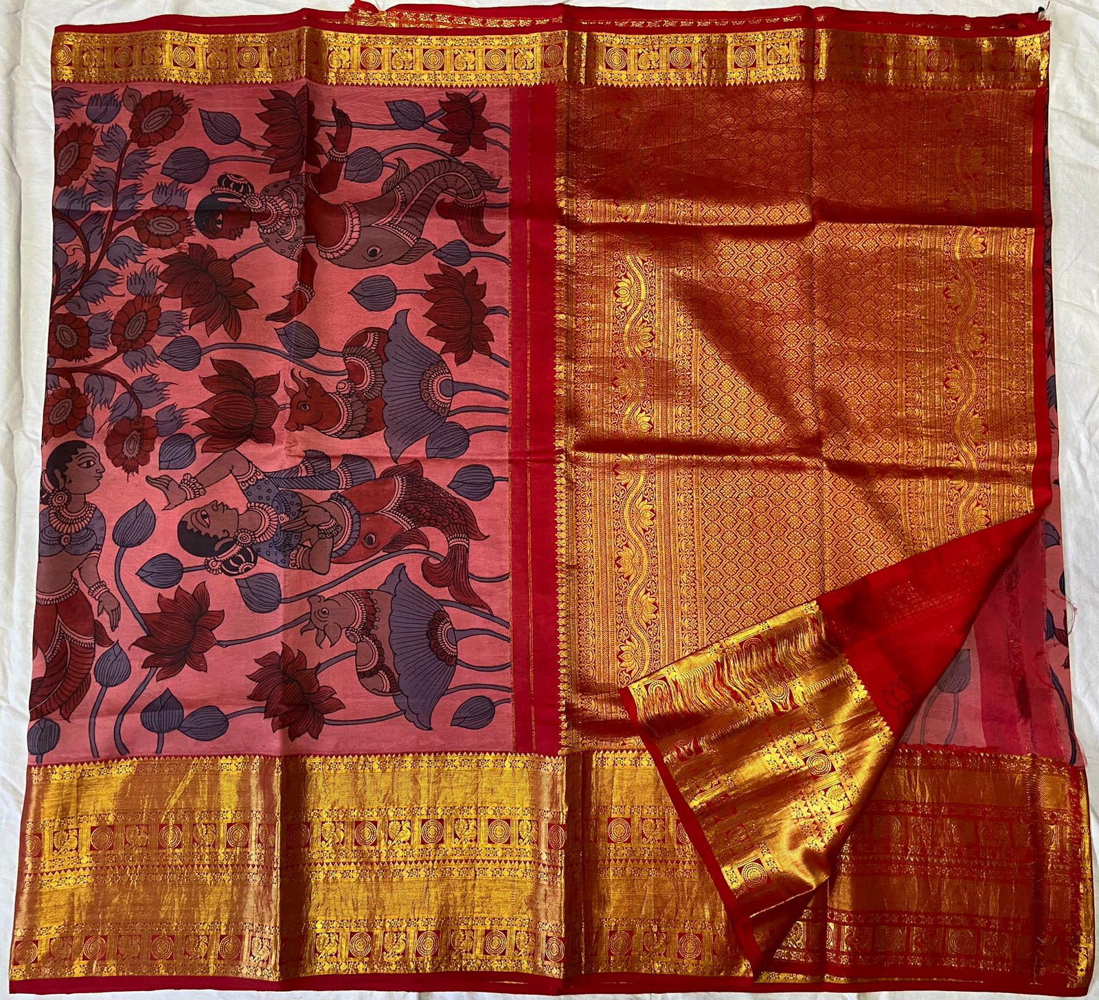Pink and red Kanchipuram silk saree with golden zari border and mythological figure patterns.