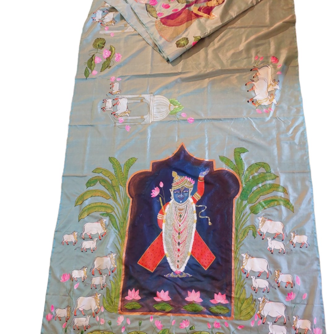 Hand-painted Pichwai Tussar silk saree with Krishna and cow design. Traditional Indian saree featuring intricate artwork.
