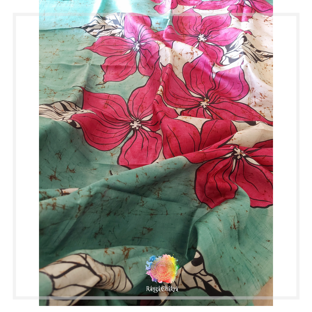 Floral Batik Silk Saree: Hand-painted pink flowers on a teal silk fabric.