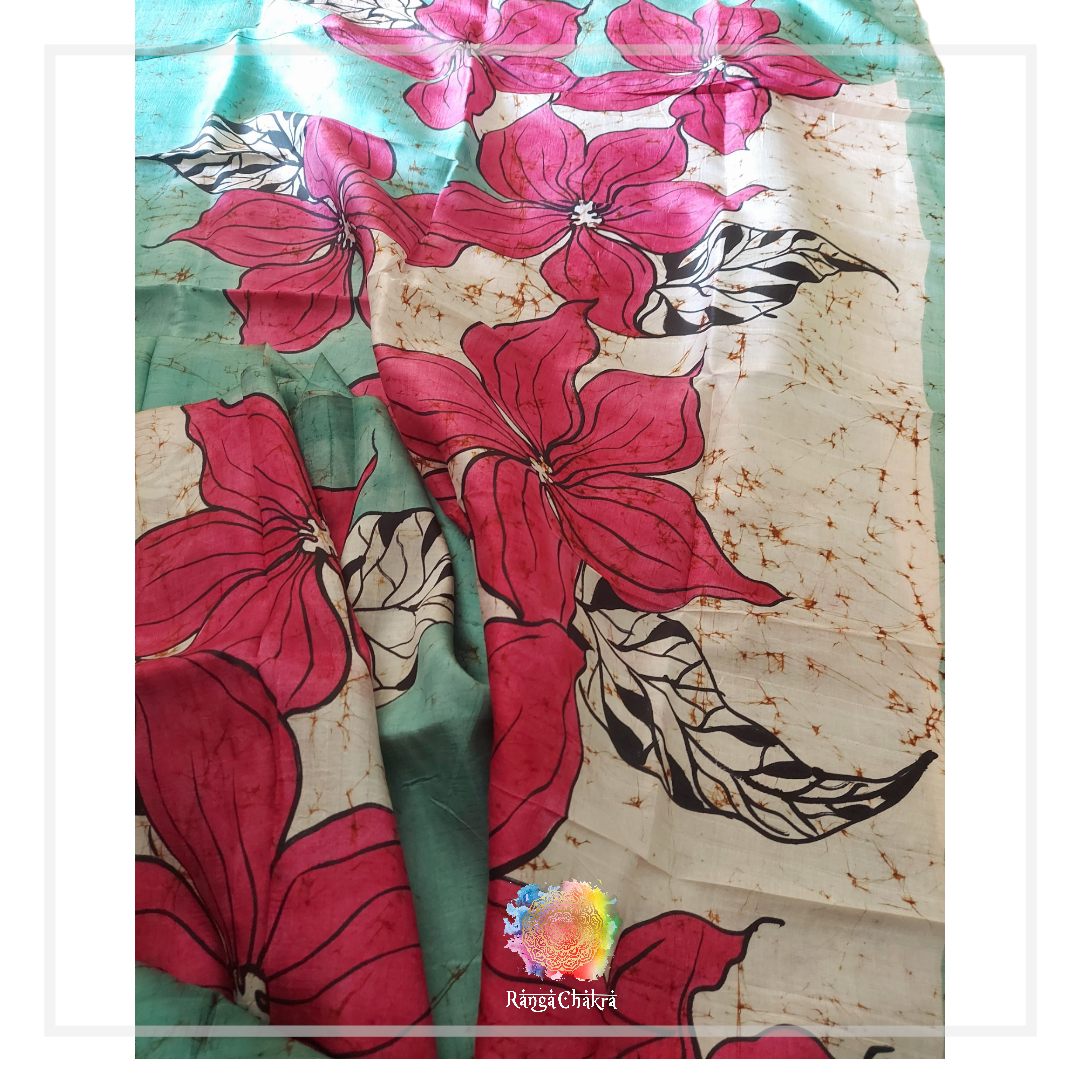 Hand-painted Batik silk saree featuring large pink floral designs and delicate leaf patterns.