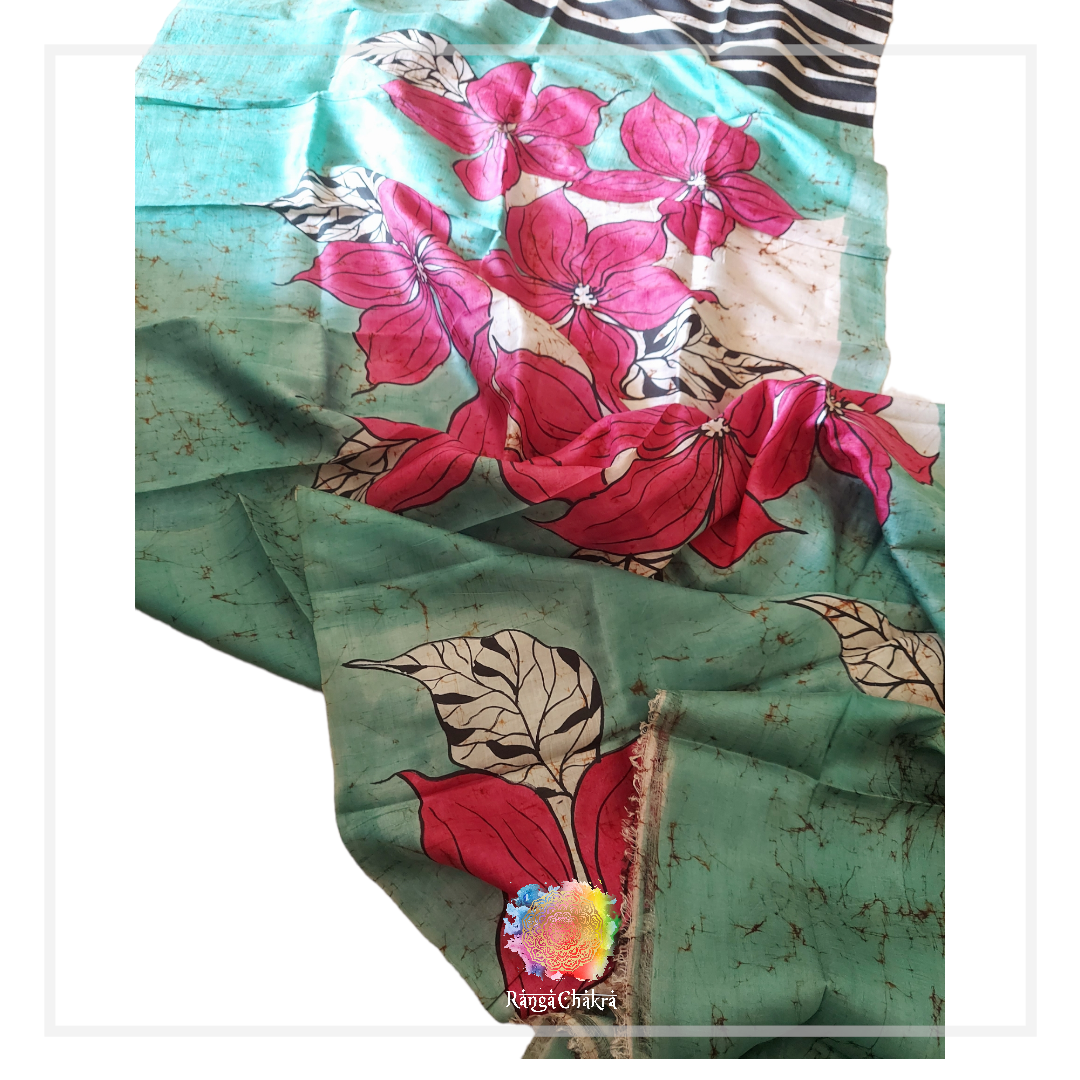 Hand-batik silk saree with vibrant pink floral pattern on a teal background.