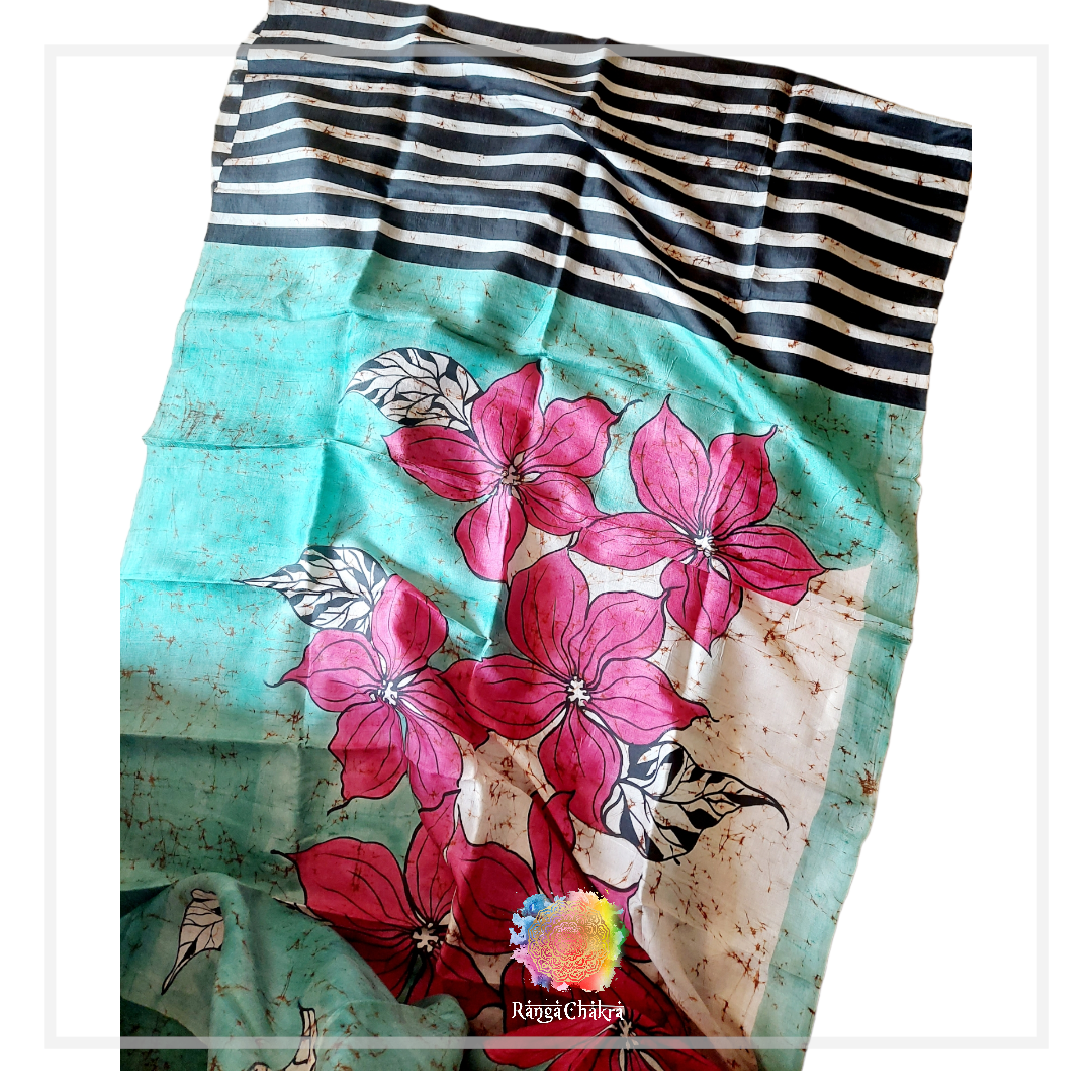 Hand-painted batik silk saree with pink floral and striped patterns.