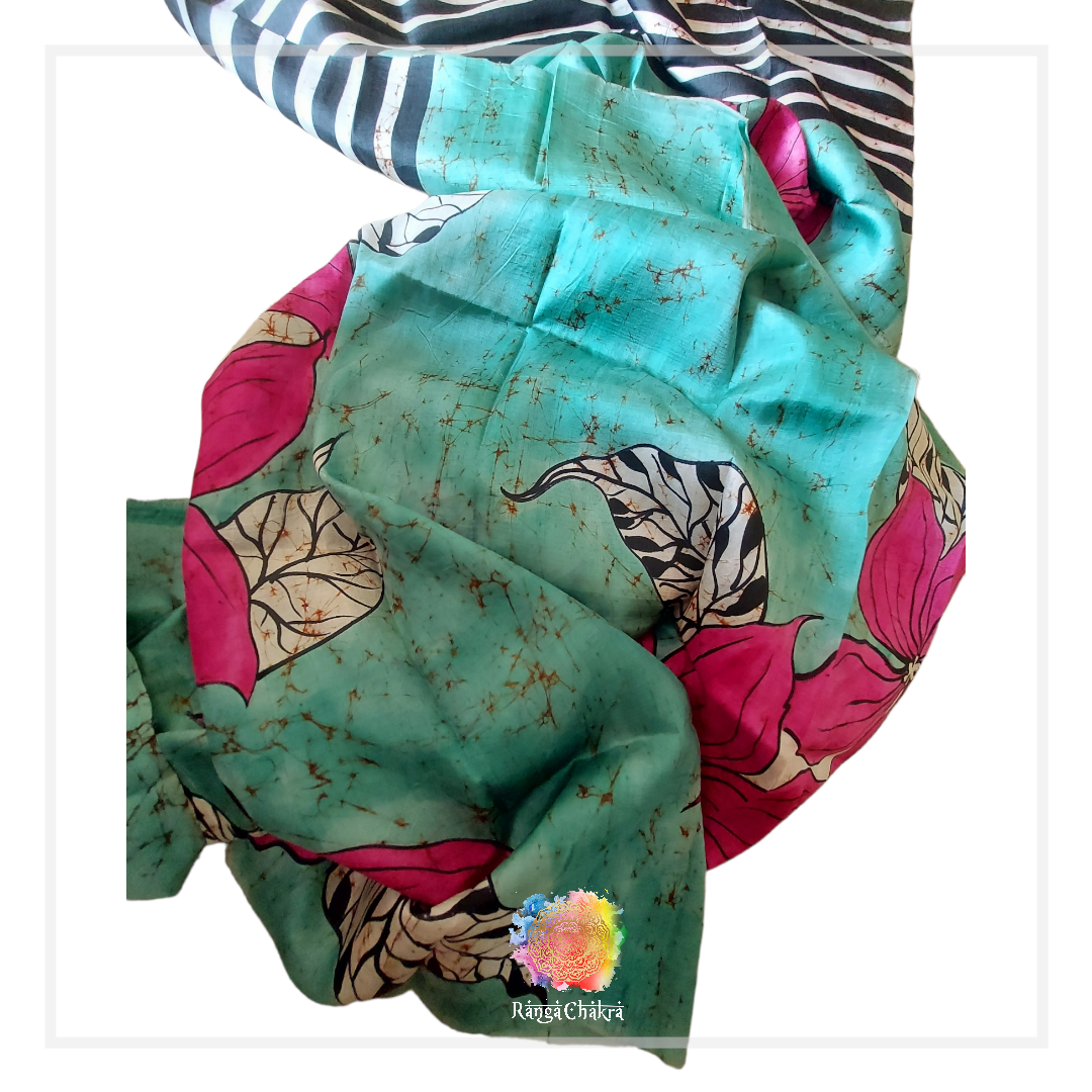 Hand-painted Batik silk saree with floral and striped patterns in teal, pink, and black.