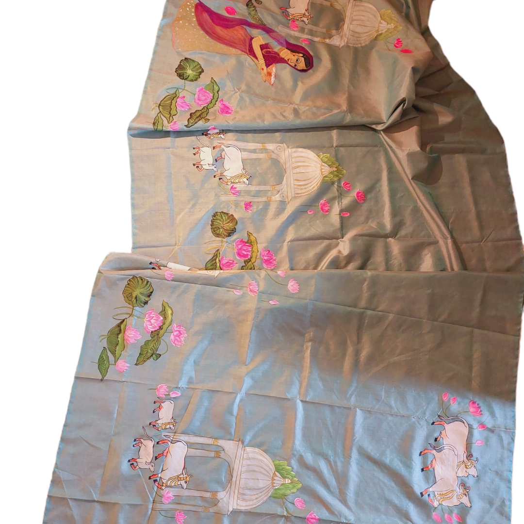 Hand-painted Pichwai Tussar silk saree featuring cows and lotus designs in blue.