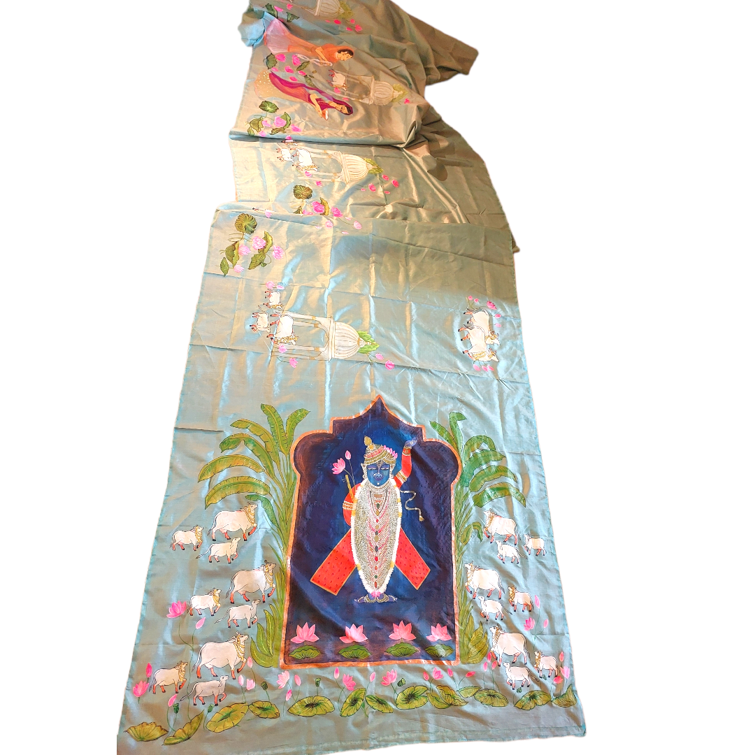 Blue Tussar silk saree with hand-painted Pichwai cow and Krishna design.