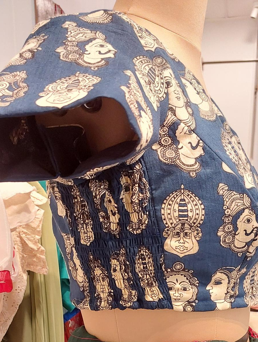 Shop our Pure Cotton Smocked readymade blouses. Wear Blouses like A tee! Get the perfect, bespoke fit for handloom sarees. Shop the latest trends in readymade Smocking blouses and made-to-order styles. Shop now and experience luxury tailoring. Handloom Kalamkari printed Cotton Indigo shade mix Matched Blouse with princess cut , lining and no hook. Wear like a T shirt