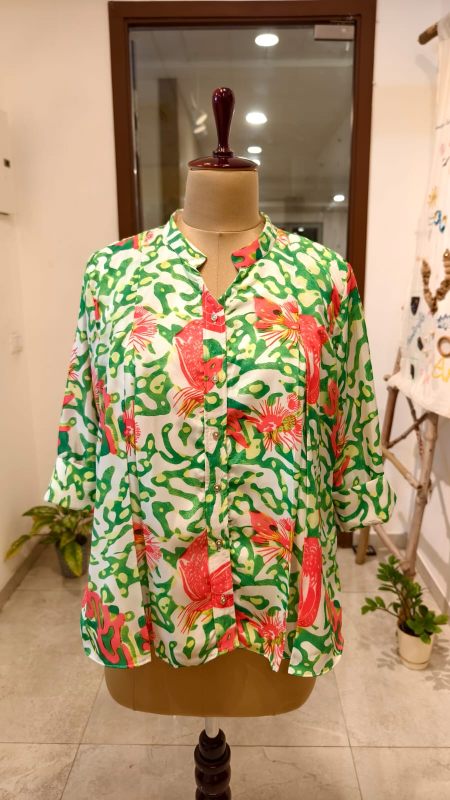 Elevate your vacation style with our Tropical Abstract Artwork Tunic. Featuring a vibrant green and pink hand-painted print, mandarin collar, and breathable fit. Perfect for resort wear and summer outings. Shop the collection!
