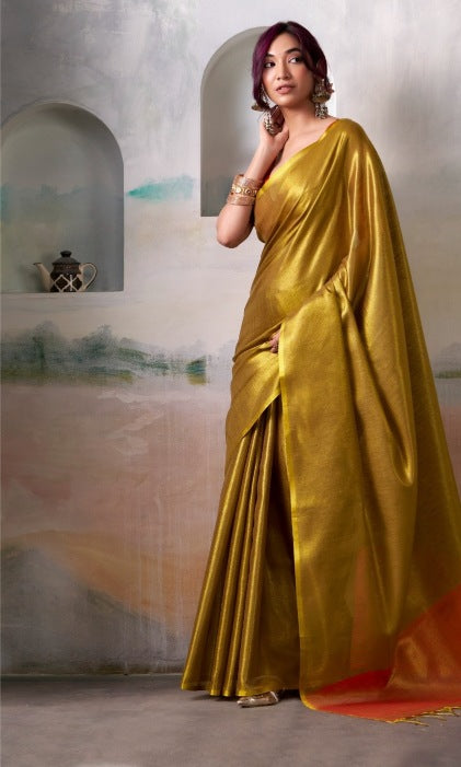 A lady wearing a golden tussue silk for diwali festive