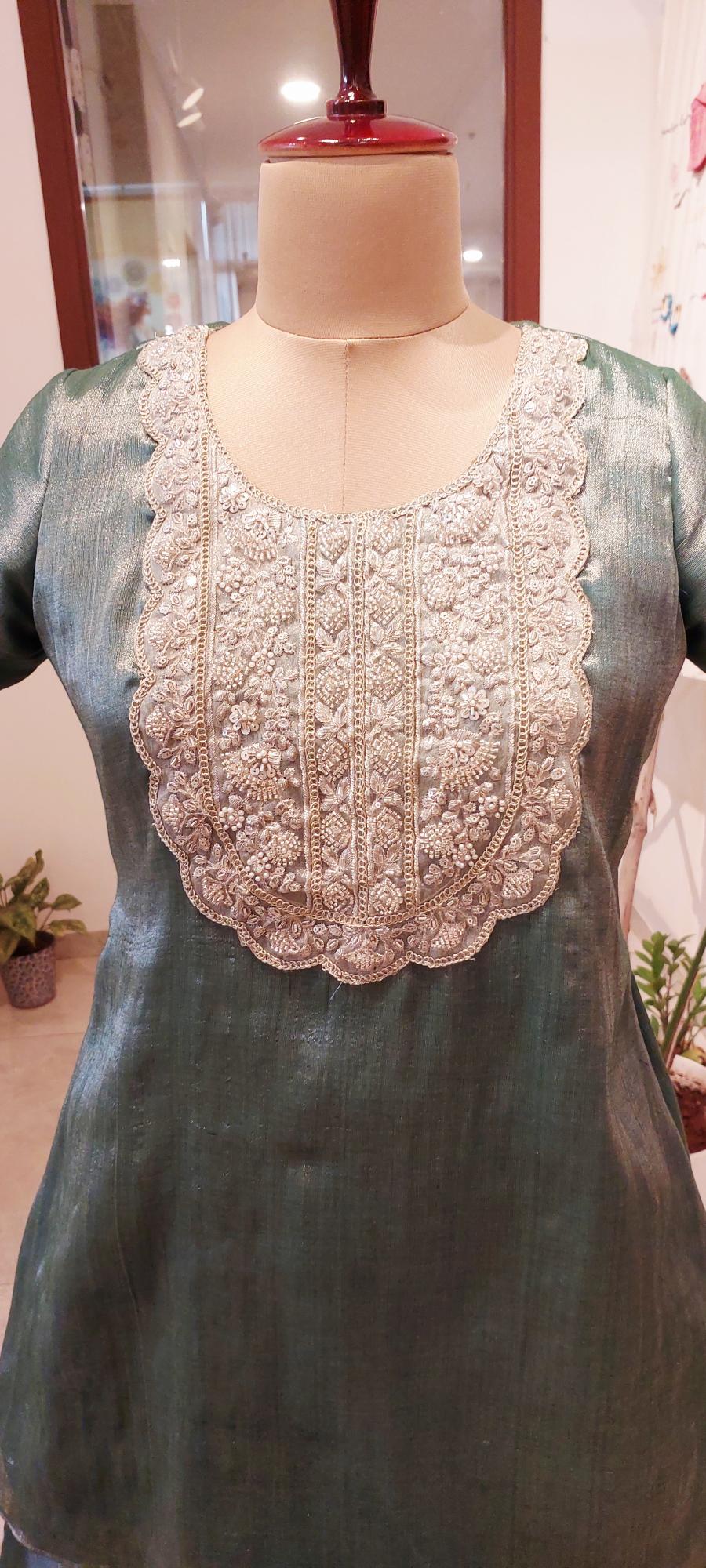 Step into subtle luxury with our Handcrafted Sea Green Mul Tissue Kurta & Layered Umbrella Flared Pants set. Light, shimmering, and intricately embroidered for festive elegance. Shop now